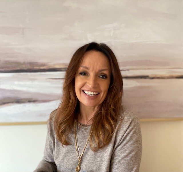 picture of female with picture seascape in background